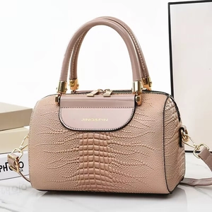 Chic lizard pattern boston bucket bag in light pink with gold hardware and shoulder strap