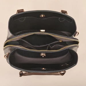 Top view showing multiple interior compartments and magnetic closures of the leather handbag