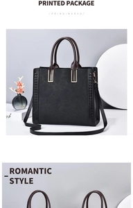 Dettaglio della borsa tote in pelle nera con goffratura pizzo e finiture metalliche oro