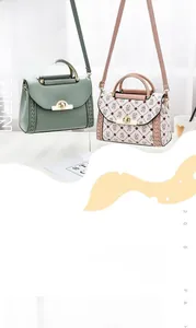 Detail of color-block handbags with metal top handles, turn locks and woven side accents