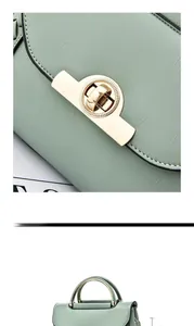 Detail of light green leather handbag featuring a golden turn-lock and premium stitching