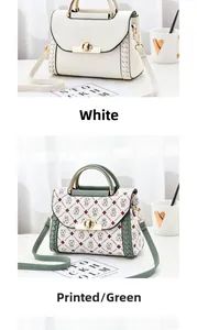 Close-up of stylish handbag with round gold buckle and removable shoulder strap detail