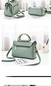 Detailed view of sage green tote bag with lychee texture and metallic top handles