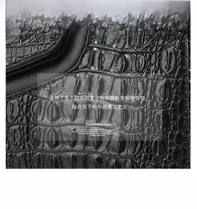 Detailed close-up of premium ostrich texture and matte finish on a large shoulder bag