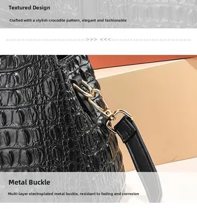 Close-up of black ostrich texture leather and gold-plated hardware on a large tote bag