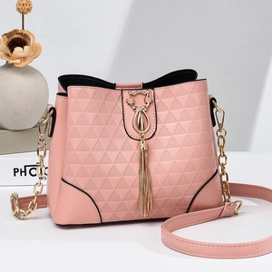 Pink geometric embossed bucket bag with gold cat buckle and metallic tassel detail