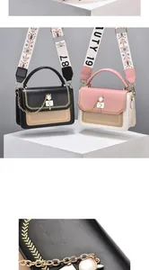 Detail of metal cat clasp and embroidered wide strap on fashionable crossbody bag