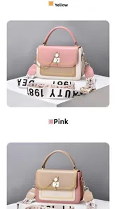 Detail view of colorful crossbody bags with cat-shaped metal buckle and wide strap