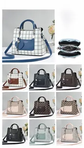 Close-up of high-quality PU leather handbag featuring checkered pattern and heart charm