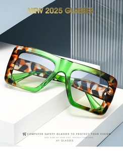 Detail of green transparent square glasses with tortoiseshell texture on a white stand