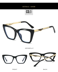 Cat-eye glasses detail showing black frames with gold hollow-out metal temples