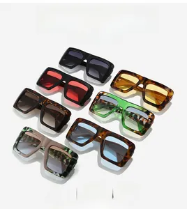 Detailed display of oversized square sunglasses in black, green, and tortoise shell frames