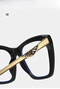 Detail view of black frame eyewear showing lightweight elastic hinge with gold metal decor