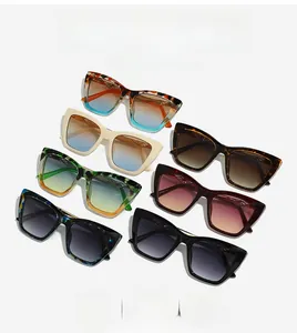 Detail view of stylish cat-eye sunglasses with gradient lenses in diverse trendy frame colors