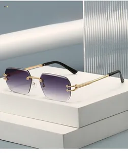 Detail of purple gradient rimless sunglasses with textured gold metal temples on a stand