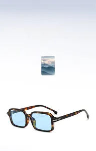 Detail view of square tortoiseshell sunglasses with light blue lenses and metal accents