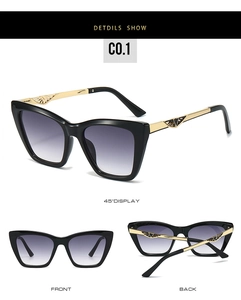 Detail view of cat eye sunglasses with black frames and hollow gold metal temples