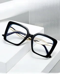 Detailed view of square anti-blue light glasses with gold metal temples on a white stone base