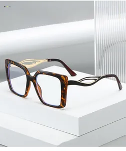 Detailed close-up of tortoise shell square glasses with hollow golden metal temples