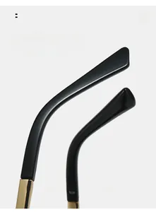 Detail of ergonomic black and gold cat-eye sunglasses legs with curved comfort fit design