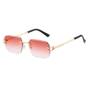 Polygonal rimless sunglasses with red gradient lenses and golden metal frame shown at 45-degree angle