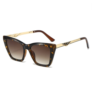 Stylish cat-eye tortoiseshell sunglasses with gold metal temples and gradient brown lenses