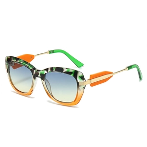 Fashionable cat eye sunglasses with multi-color frame and yellow-blue gradient lenses