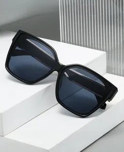 Detail of square black sunglasses on geometric display with grey tinted lenses