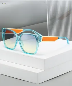Detail of blue acetate frame sunglasses with orange color block and gradient lenses