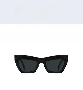 Detailed front view of black cat-eye sunglasses with unique textured wavy frame edges