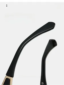 Detail of glossy black temples with gold hinges and ergonomic curved design for comfort
