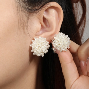 Close-up of cluster pearl stud earrings on model showing elegant texture and size