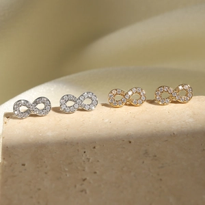 Elegant infinity zircon earrings in gold and silver finish with micro-pave stones