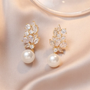 Elegant gold drop earrings with marquise crystals and large white round pearls on satin