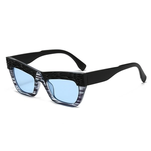 Oversized cat eye sunglasses with textured black frames and light blue lenses