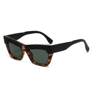 Chic oversized cat-eye sunglasses with textured black frames and tortoise pattern
