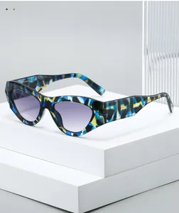 Detail of colorful tortoiseshell cat eye sunglasses on a minimalist white geometric stand