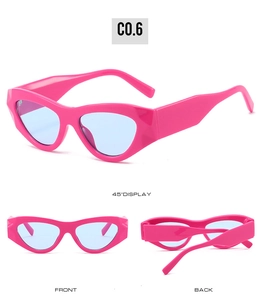 Detail view of pink cat-eye sunglasses with thick temples and light blue lenses