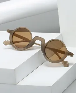 Detail of retro round glasses with thick grey translucent frames and geometric bridge