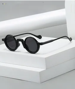 Detail shot of vintage round black sunglasses on geometric architectural props