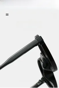 Detailed close-up of premium flexible hinges and glossy black frames on retro sunglasses
