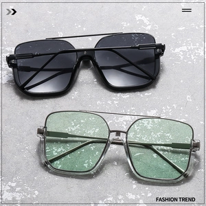 Detail view of square oversized sunglasses with double metal bridge and gradient lenses