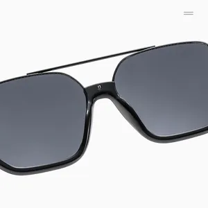 Detailed close-up of double-beam metal decoration on black square semi-rimless sunglasses