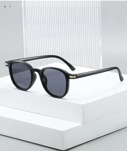 Detailed close-up of golden metal hinge on vintage black oval sunglasses frame
