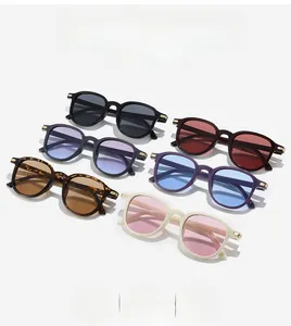 Fashionable oversized oval sunglasses in various frame colors with gold metal temple details