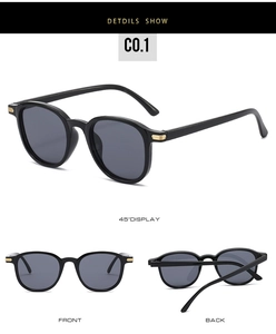 Detail view of oval sunglasses with a gold wavy metal hinge accent and black frame