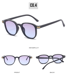Detail view of oval sunglasses with gold hinge accents and purple gradient lenses
