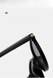 Detail of high-elastic black frame glasses with golden metal stripe hinge design