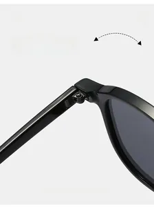 Detail of durable reinforced metal hinge on black oval sunglasses with smooth folding action