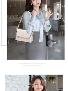 Detail of cream white leather shoulder bag with metal chain strap in indoor modern setting